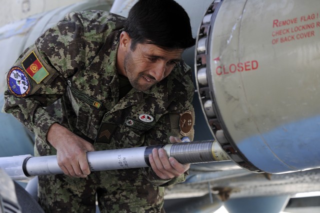Afghan airmen loads a MI-17 helicopter