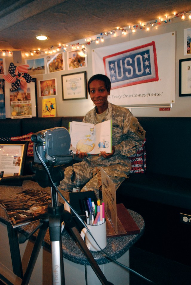 Spc. Catawaba Hughes displays a book she recorded for her family during a visit Oct. 14 to the Mobile United Service Organizations. It made its first-ever visit to the post on Oct. 13-14, building the morale of Soldiers, mainly the members of the War...