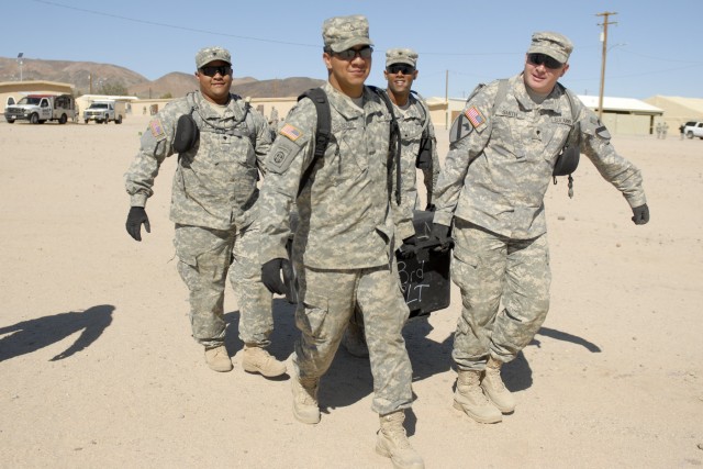 FORT IRWIN, California  - Soldiers with 3rd Brigade Special Troops Battalion, 3rd Brigade Combat Team, 1st Cavalry Division, haul a box of radios to the motorpool of the National Training Center at Fort Irwin, Calif. The troops are preparing their...