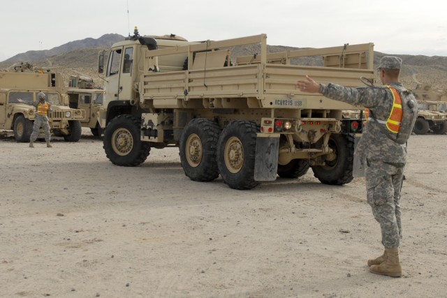 FORT IRWIN, California  - Spc. Billy Chellette (right), from Fort Hood, Texas, and Spc. Salem Umana, from Converse, Texas, both with 215th Brigade Support Battalion, 3rd Brigade Combat Team, 1st Cavalry Division, guide a light medium tactical...