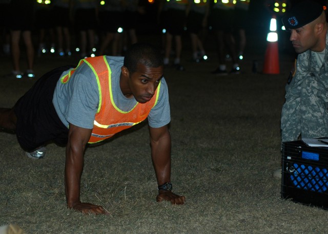FORT HOOD, Texas-Maj. Cory McKoy, an intelligence analysis officer in Headquarters and Headquarters Battery, 41st Fires Brigade, locks out at the top of a push up while competing in the brigades' officer APFT Challenge last week.  McKoy placed third ...
