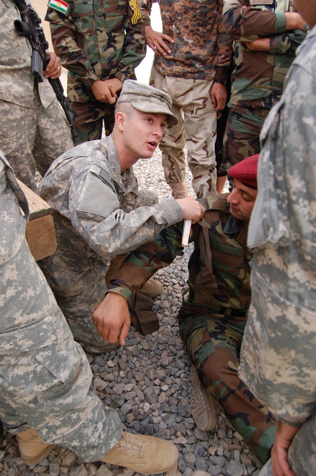CONTINGENCY OPERATING SITE MAREZ, Iraq -Pfc. Richard Darby, of Richardson, Texas, a combat medic assigned to 1st Squadron, 9th Cavalry Regiment, 4th Advise and Assist Brigade, 1st Cavalry Division, teaches members from the Iraqi Security Forces how t...