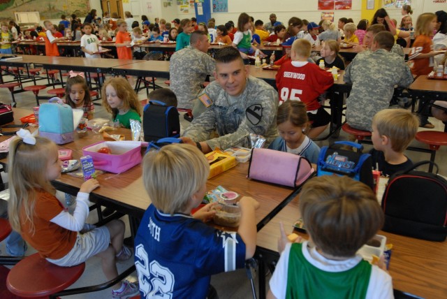 BELTON, Texas- San Antonio native, 2nd Lt. Ronald Youngblood, a fire support officer with 2nd Battalion, 5th Cavalry Regiment, 1st Brigade Combat Team, 1st Cavalry Division, eats his lunch with students of Leon Heights Elementary School as part of th...