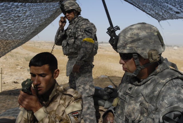 CONTINGENCY OPERATING SITE MAREZ, Iraq- Staff Sgt. Rodolfo Servin (right), a forward observer assigned to the 1st Squadron, 9th Cavalry Regiment, 4th Advise and Assist Brigade, 1st Cavalry Division, teaches an Iraqi Soldier assigned to 6th Brigade, 3...