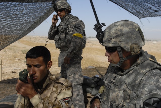 CONTINGENCY OPERATING SITE MAREZ, Iraq- Staff Sgt. Rodolfo Servin (right), a forward observer assigned to the 1st Squadron, 9th Cavalry Regiment, 4th Advise and Assist Brigade, 1st Cavalry Division, teaches an Iraqi Soldier assigned to 6th...
