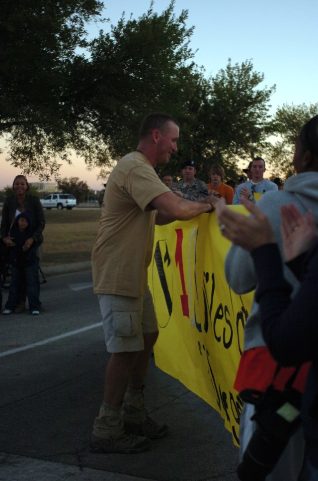 FORT HOOD, Texas - Lt. Col. Jack Usrey rips through the finish line as he completes a 100-mile trek near the 1st Cavalry Division Headquarters, Oct. 29. Usrey, the division personnel officer, completed ten, ten-mile loops around the 1st Cav. Div....