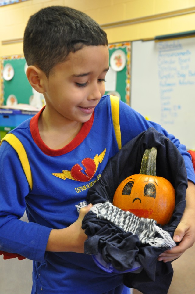 Bundle of joy: Second-graders play parents to pumpkins