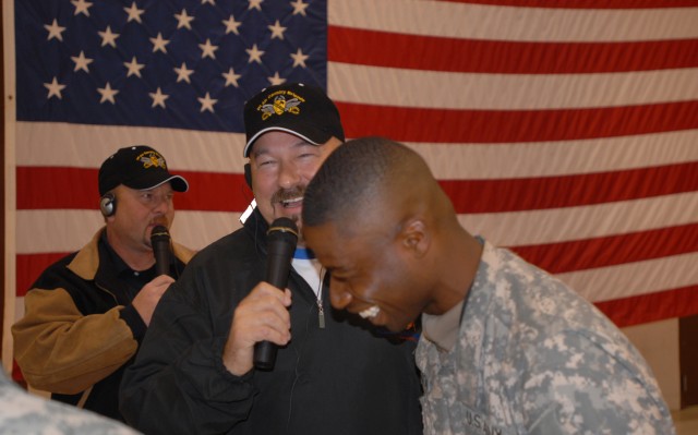 FORT HOOD, Texas - Staff Sgt. Leander Johnson (right), of Cincinnati, 615th Aviation Support Battalion, 1st Air Cavalry Brigade, 1st Cavalry Division, laughs along with radio personality Zack Owen during a live broadcast Nov. 4. Owen is the...