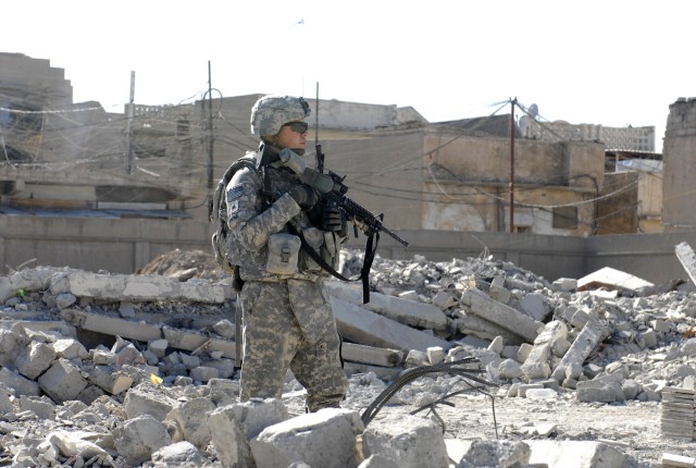 CONTINGENCY OPERATING SITE MAREZ, Iraq-Sgt. Mario Pena, a field artilleryman assigned to the 5th Battalion, 82nd Field Artillery, 4th Advise and Assist Brigade, 1st Cavalry Division, provides security during a combined patrol with members of the...