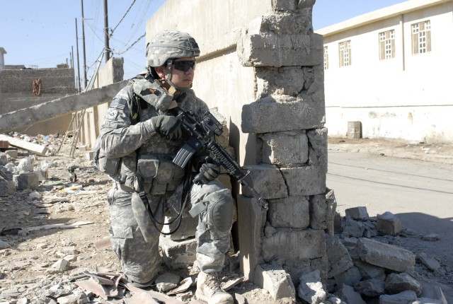 CONTINGENCY OPERATING SITE MAREZ, Iraq-Pfc. Gabriel Moya, a field artilleryman assigned to the 5th Battalion, 82nd  Field Artillery, 4th Advise and Assist Brigade, 1st Cavalry Division, provides security during a combined patrol with members of...