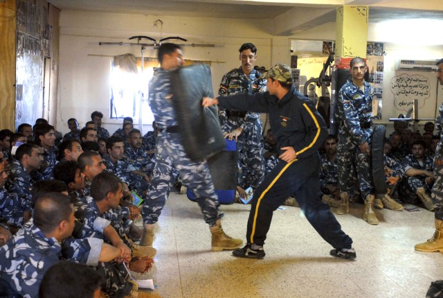 CONTINGENCY OPERATING SITE MAREZ, Iraq-An Iraqi police instructor, trained by U.S. Soldiers and civilian police advisors, teaches Iraqi IP recruits blocking and punching maneuvers during a self-defense class, Nov. 4. Soldiers from Task Force Shield, ...