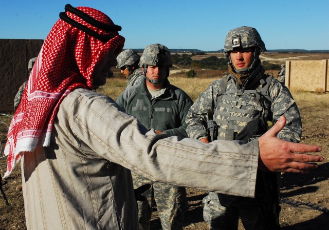 FORT HOOD, Texas- 1st Lt. Ross Cargile (right), a platoon leader with 3rd Battalion, 82nd Field Artillery Regiment, 2nd Brigade Combat Team, 1st Cavalry Division, talks to a local village leader through an interpreter during training on Fort Hood,...