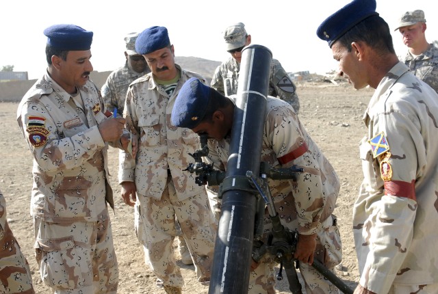 CONTINGENCY OPERATING SITE MAREZ, Iraq Soldiers assigned to the Iraqi Army's 6th Brigade, 3rd Division, make adjustments to the 120mm mortar system during training Nov. 8.  Soldiers of the 4th Advise and Assist Brigade, 1st Cavalry Division, are...