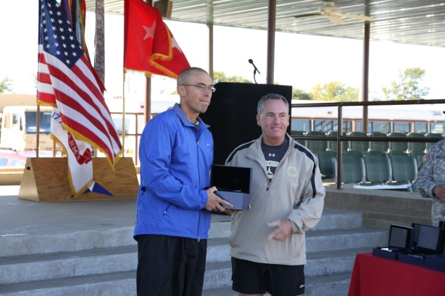 FORT HOOD, Texas-Spc. Shawn Richards (left), an infantryman from Company B, 2nd Battalion, 8th Cavalry Regiment, 1st Brigade Combat Team, 1st Cavalry Division, receives the award for the best overall time in male category for the half-marathon, here,...