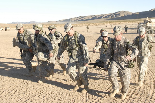 FORT IRWIN, Calif. - Soldiers from 215th Brigade Support Battalion, 3rd Brigade Combat Team, 1st Cavalry Division, transport casualties to a safe area for further treatment, Nov.r 2, during a month-long training exercise at the National Training Cent...