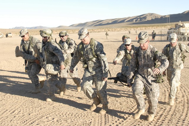 FORT IRWIN, Calif. - Soldiers from 215th Brigade Support Battalion, 3rd Brigade Combat Team, 1st Cavalry Division, transport casualties to a safe area for further treatment, Nov.r 2, during a month-long training exercise at the National Training...