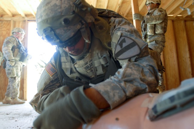 FORT IRWIN, Calif. - Pvt. Michael Viramontes, a cavalry scout with B Troop, 6th Squadron, 9th Cavalry Regiment, 3rd Brigade Combat Team, 1st Cavalry Division, performs buddy aid to a simulated casualty before the arrival of a medic Nov. 1 during a...