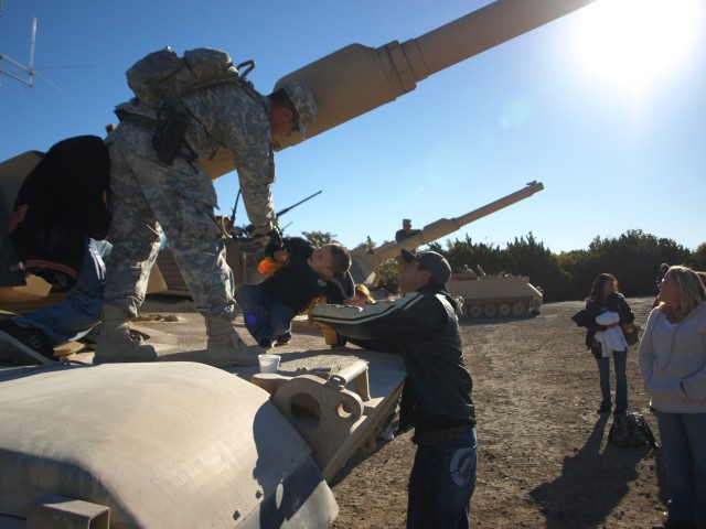 FORT HOOD, Texas - Family members of Soldiers assigned to the 2nd Battalion, 8th Cavalry Regiment, 1st Brigade Combat Team, 1st Cavalry Division, climb in and around the vehicles put on display for the Stallion Family Day Gunnery, here, Nov. 5....