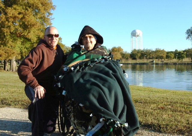 TEMPLE, Texas- Sgt. David Eskew, the training noncommissioned officer for Headquarters and Headquarters Company, 2nd Brigade Combat Team, 1st Cavalry Division, and Andy Fabrizi, a World War II veteran, take a break by a pond during the Alzheimer's...