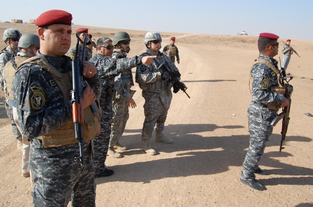 CONTINGENCY OPERATING SITE MAREZ, Iraq -Col. Sa'ad Banaiean Abied (center), commander of the Mosul Federal Police, shows Soldiers assigned to Task Force Spear, 4th Advise and Assist Brigade, 1st Cavalry Division, the progress during a cordon and...