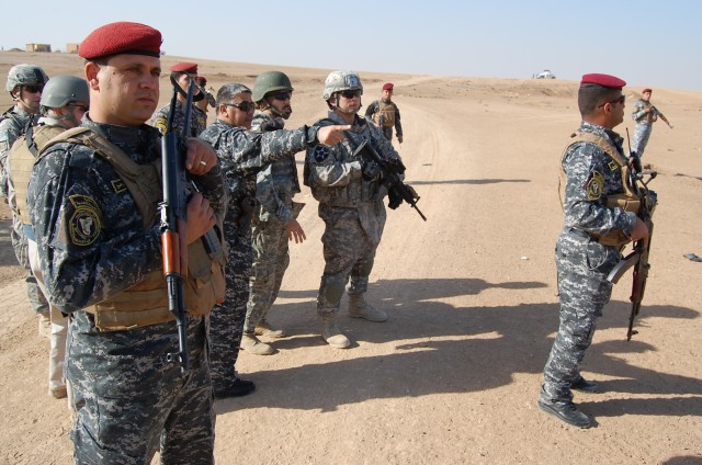 CONTINGENCY OPERATING SITE MAREZ, Iraq -Col. Sa'ad Banaiean Abied (center), commander of the Mosul Federal Police, shows Soldiers assigned to Task Force Spear, 4th Advise and Assist Brigade, 1st Cavalry Division, the progress during a cordon and sear...