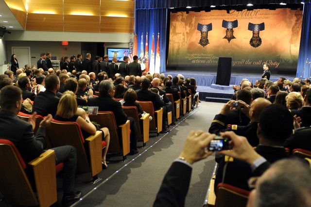 Medal of Honor recipient Army Staff Sgt. Salvatore Giunta and his team members from Company B, 2nd Battalion, Airborne, 503rd Infantry Regiment, stand to be recognized during Giunta's induction ceremony into the Hall of Heroes at the Pentagon,...