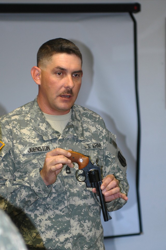 FORT HOOD, Texas- Sgt. 1st Class Chad Johnston, of Headquarters and Headquarters Battery, 1st Battalion, 21st Field Artillery Regiment, 41st Fires Brigade, a native of Lawton, Okla., uses a .357-caliber revolver to demonstrate proper loading and...