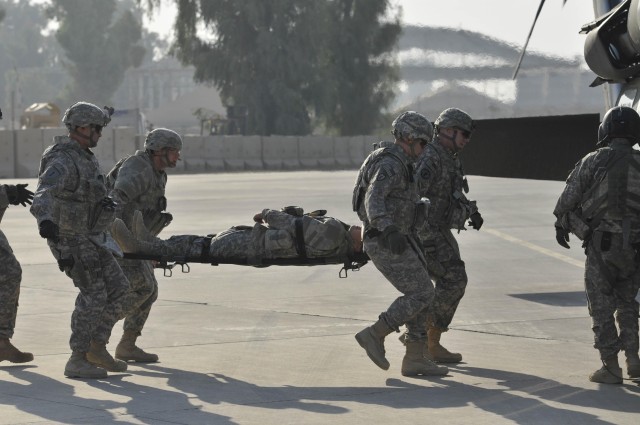 CONTINGENCY OPERATING SITE MAREZ - Soldiers of Headquarters and Headquarters Battery, 5th Battalion, 82nd Field Artillery, experience the change in weight and movement as they load a Soldier on to a helicopter while wearing their gear Nov. 18 during ...