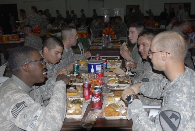 JOINT SECURITY STATION INDIA, Iraq- Soldiers assigned to the 2nd Battalion, 7th Cavalry Regiment, 4th Advise and Assist Brigade, 1st Cavalry Division, enjoy their Thanksgiving Day meal, Nov. 25. Cooks in the unit worked all day to prepare the meal...