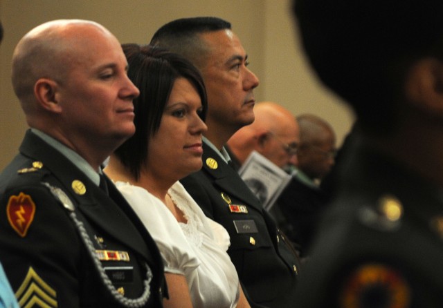 Sergeant 1st Class Charles Hibbs, a paralegal noncommissioned officer with the 3d Sustainment Command (Expeditionary), his wife Teresa, and Sgt. 1st Class Stanley Horn, an operations NCO with the 3d ESC, wait for the start of the United States Army H...