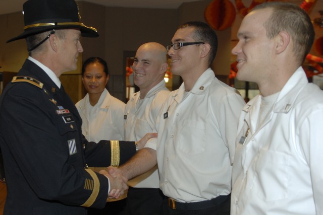 FORT HOOD, Texas - Maj. Gen. Daniel Allyn, the commanding general for the 1st Cavalry Division, recognizes the hard work of Spc. John Vidrio, a cook with G Forward Support Co., 2nd Bn., 82nd Field Artillery Regt., 3rd Bde. Combat Team, 1st Cav. Div. ...