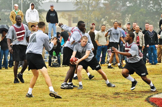 Geoffrey Uhal, center, of the officers looks for a teammate as senior NCO defenders converge Nov. 24 during the 11th Engineer Battalion's annual Turkey Bowl at Stewart-Watson Field. The officers scored twice in overtime to pick up a 10-8 victory,...