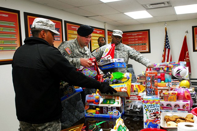 FORT HOOD, Texas-The Soldiers from 1st Battalion, 21st Field Artillery Regiment, 41st Fires Brigade, help load toys donated to the Exceptional Family Member Program toy drive, Dec. 1. The EFMP toy drive contributions are given to children in the...