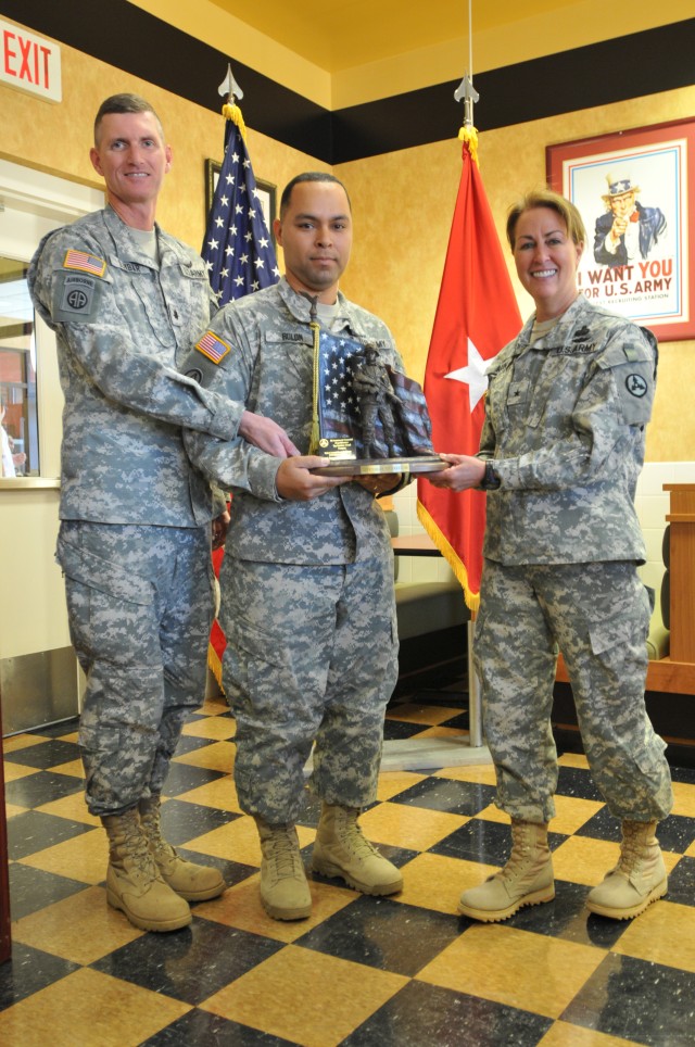 (Left to right) Lieutenant Col. Layton Dunbar, the 24 Transportation Battalion commander, and Sgt. Charles Manuel, the 335th Transportation Detachment retention Noncommissioned Officer, receive the company-level Top Sustainer award from Brig. Gen....