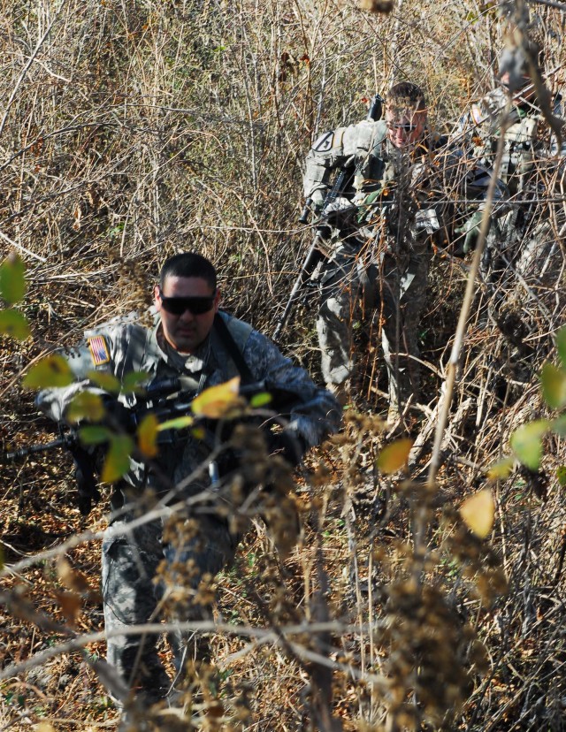 FORT HOOD, Texas - From front to rear, Chief Warrant Officer 2 Gabe Gomez, of Alvin, Texas, a UH-60 Blackhawk helicopter pilot; Spc. Patrick Dunkoe, from Long Beach, Calif.; and Spc. Robert Williams, of Oklahoma City, all members of Company C,...