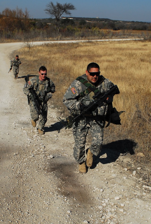FORT HOOD, Texas - From front to rear, Chief Warrant Officer 2 Gabe Gomez, a native of Alvin, Texas, a UH-60 Blackhawk helicopter pilot; Spc. Patrick Dunkoe, a native of Long Beach, Calif., a Blackhawk crew chief; and Spc. Robert Williams, a...