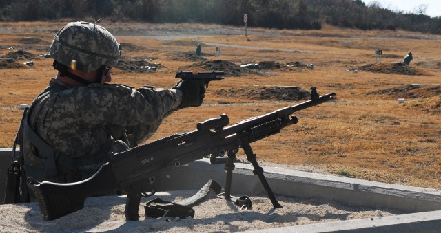 FORT HOOD, Texas - Spc. Patrick Dunkoe, from Long Beach, Calif., a Blackhawk crew chief for Company C, Task Force Spear Head, 1st Air Cavalry Brigade, 1st Cavalry Division, fires his 9mm pistol during a timed and evaluated downed aircraft training...