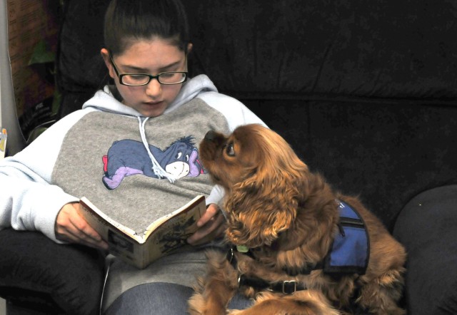 Students share stories with a furry friend