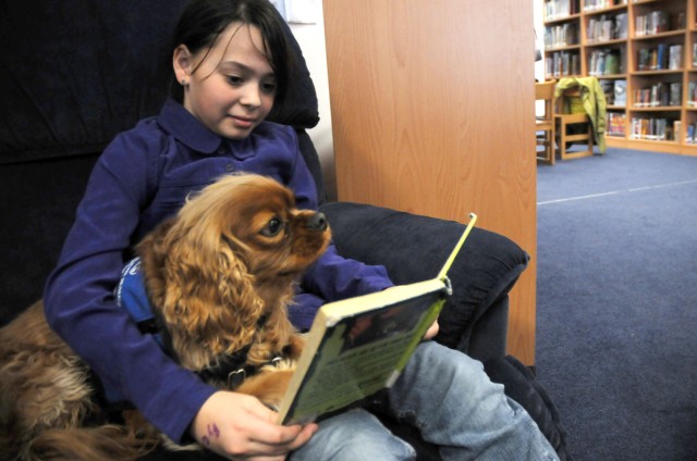 Students share stories with a furry friend