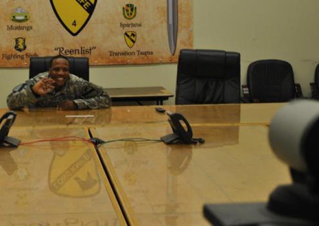 Spc. Andres Montero, training room non-commissioned officer for  A Company,  27th Brigade Support Battalion, 4th Advise and Assist Brigade, 1st Cavalry Division,  waves to his Family during the video teleconference set up by Meadows Elementary...