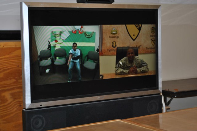 Master Sgt. Phillip Murphy, senior supply sergeant. assigned to Headquarters and Headquarters Company, 4th Advise and Assist Brigade, 1st Cavalry Division, enjoys a chat with his son, Samuel, during the video teleconference sponsored by Meadows...