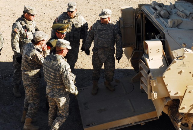 FORT HOOD, Texas- 2nd Brigade Combat Team, 1st Cavalry Division Soldiers show a Russian military officer the inside of a Bradley Fighting Vehicle during his visit to Fort Hood, Texas, Dec. 14. This officer was with a group of Russian military...