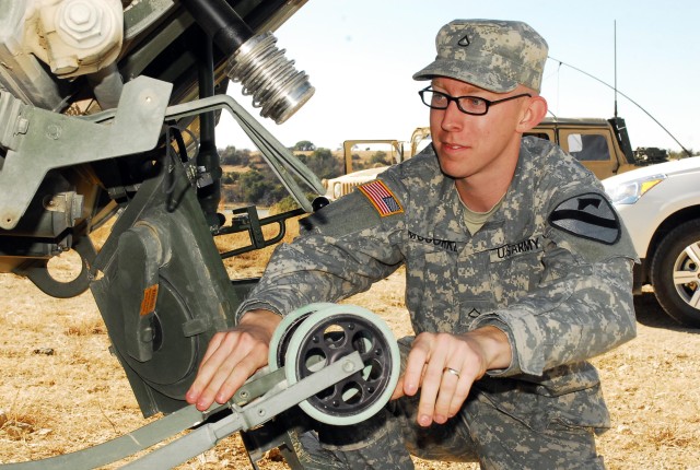 Pfc. Matthew McCorkle, a chemical operations specialist with 2nd Special Troops Battalion, 2nd Brigade Combat Team, 1st Cavalry Division, examines a double-wheel sampling system on a Stryker Nuclear, Biological, Chemical Reconnaissance vehicle...