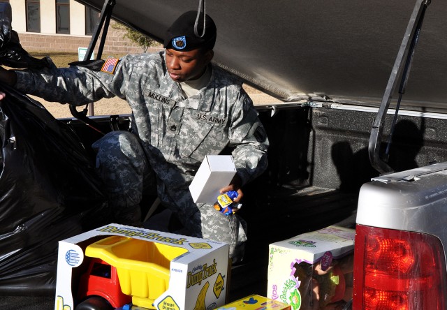 FORT HOOD, Texas-Staff Sgt. Joanquin Mullins, the 41st Fires Brigade command financial specialist, a Chicago native, unloads toys delivered by residents of Leon County to Fort Hood, Texas, Dec. 17. More than 500 hundred toys were collected for the...