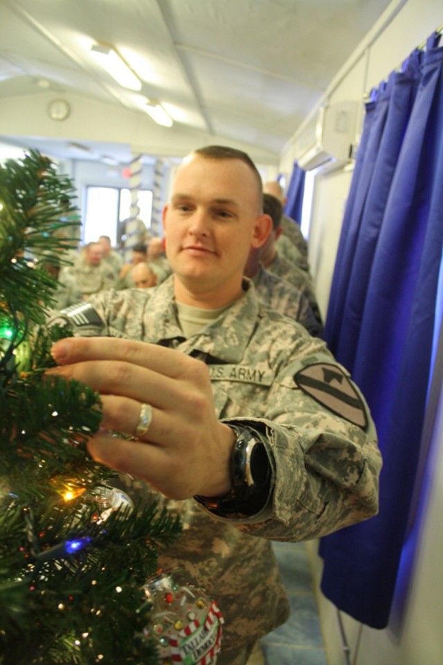 CONTINGENCY OPERATING SITE MAREZ, Iraq- Soldiers assigned to the 4th Advise and Assist Brigade, 1st Cavalry Division, stand in line to place an ornament on the Marez Chapel Christmas tree.  Each ornament holds a prayer request from each Soldier and w...