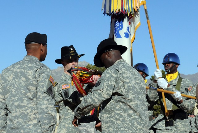 Maj. Gen. Dana J.H. Pittard, Fort Bliss commanding general stands at attention while Col. James Ryan (Middle), commander, 15th Sustainment Brigade and Command Sgt. Maj. Nathaniel Bartee Sr., the brigade’s sergeant major, uncases the brigade’s colors ...