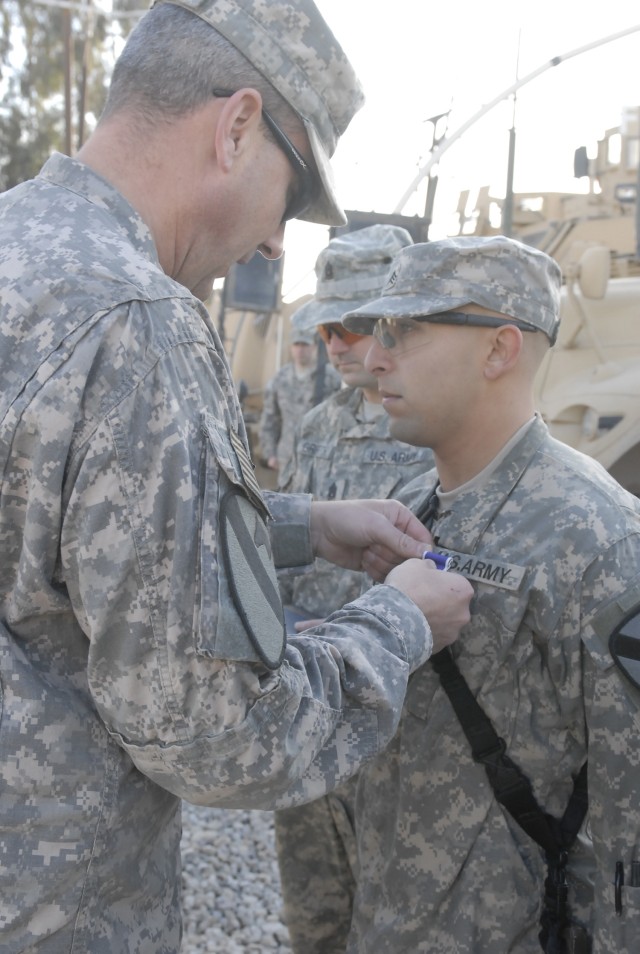 JOINT SECURITY STATION INDIA, Iraq-Col. Brian Winski (left), commander of the 4th Advise and Assist Brigade, 1st Cavalry Division, pins a Purple Heart Medal on Sgt. Melvin Cortes, a communications specialist  in Company B, 2nd  Battalion, 7th...