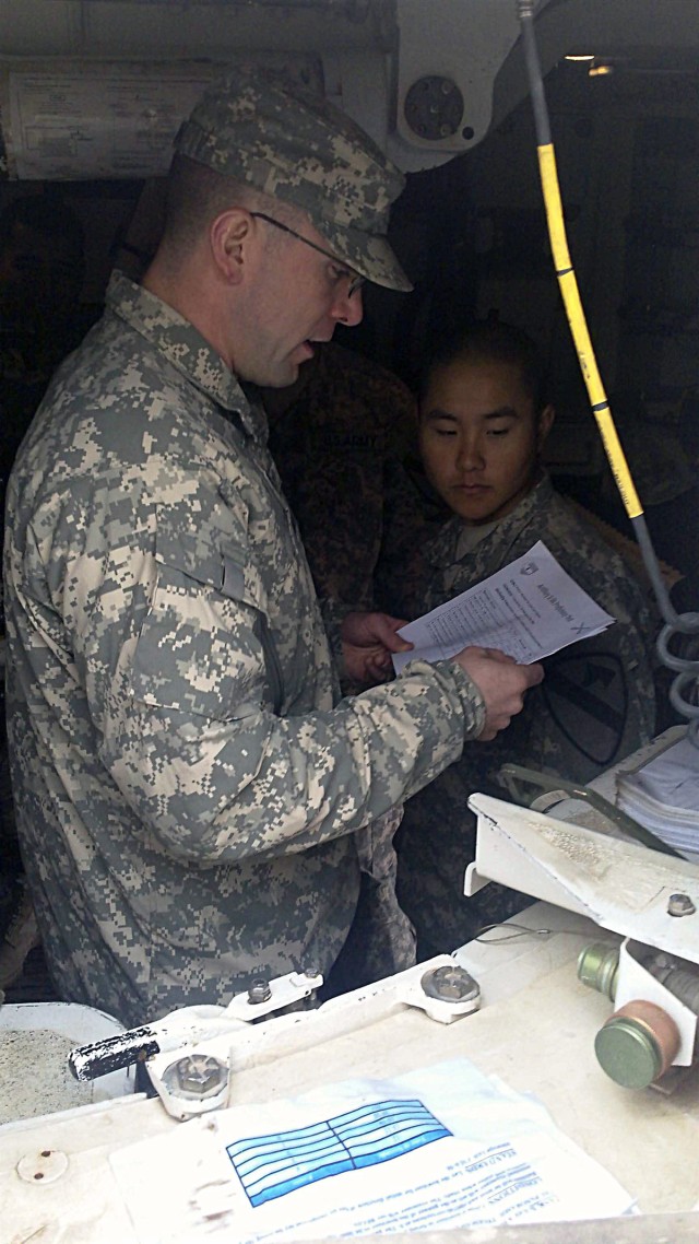 CONTINGECY OPERATING SITE MAREZ, Iraq - Staff Sgt. Steven Newman, a field artilleryman assigned to Battery B, 5th Battalion, 82nd Field Artillery Regiment, 4th Advise and Assist Brigade, 1st Cavalry Division, reads testing procedures for proper...