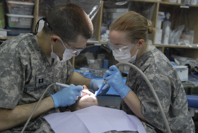 COTINGENCY OPERATING SITE MAREZ, Iraq - Capt. Bernardo Bianco (left), and Spc. Rachelle Halaska, both with Company C, 27th Brigade Support Battalion, 4th Advise and Assist Brigade, 1st Cavalry Division, fill a cavity at the troop medical clinic at Co...