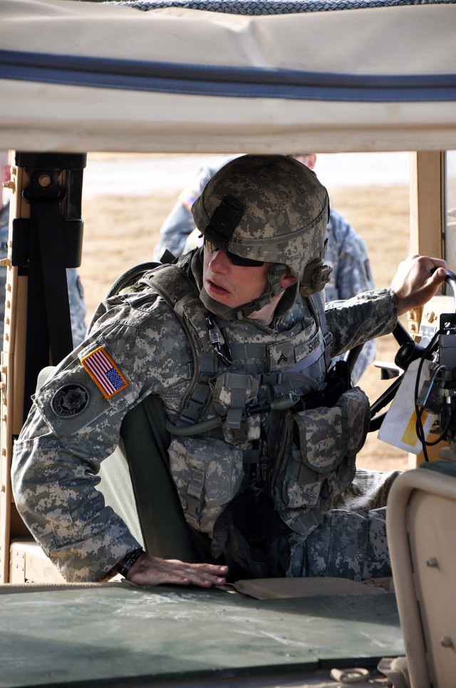 Cpl. Michael Shirk, Battery A, 26th Field Artillery Regiment (Target Acquisition Battery), 41st Fires Brigade, backs up a Humvee during a cold loading class at the Lone Star Airfield, Fort Hood, Texas, Jan. 5. The cold load training is designed to...